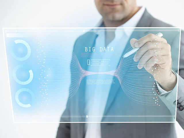 Businessman writing on a transparent touchscreen labeled Big Data, representing software solutions for hotels