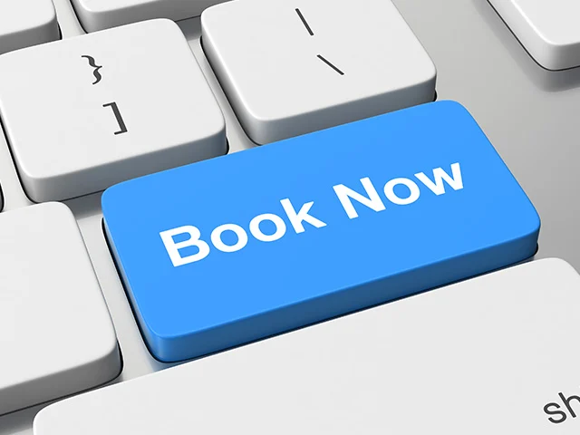 Blue Book Now key on a white computer keyboard, representing direct online hotel bookings