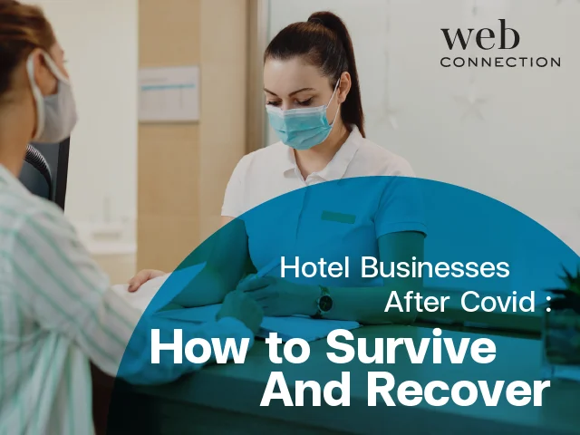 Masked hotel receptionist at the front desk serving a masked guest, illustrating how hotels recover after Covid